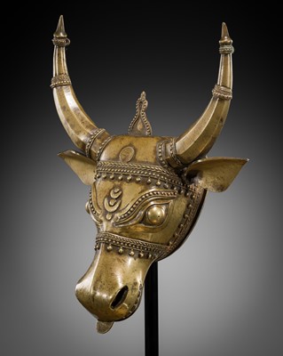 Lot 638 - A BHUTA CULT BRONZE MASK OF NANDI, KARNATAKA, 18TH-19TH CENTURY