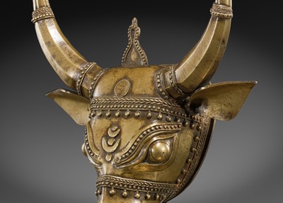 Lot 638 - A BHUTA CULT BRONZE MASK OF NANDI, KARNATAKA, 18TH-19TH CENTURY