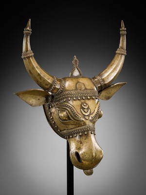 Lot 638 - A BHUTA CULT BRONZE MASK OF NANDI, KARNATAKA, 18TH-19TH CENTURY