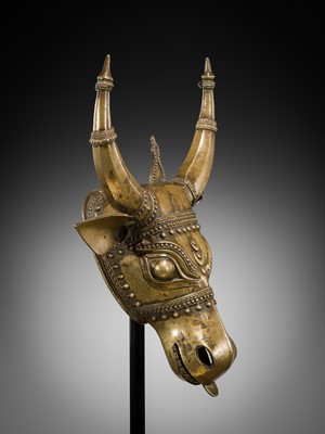 Lot 638 - A BHUTA CULT BRONZE MASK OF NANDI, KARNATAKA, 18TH-19TH CENTURY