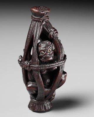 Lot 155 - SHIGEMASA: A STAINED WOOD NETSUKE OF A “TRAPPED” ONI