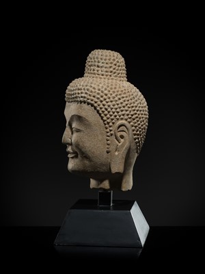 A FINE LIMESTONE HEAD OF BUDDHA, LATE NORTHERN WEI DYNASTY, 6TH CENTURY