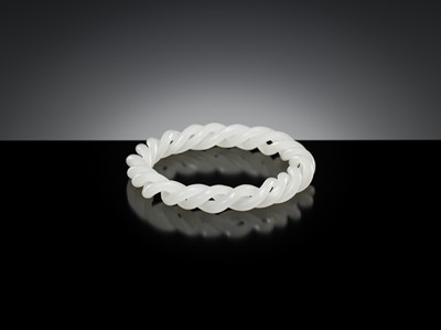 Lot 465 - A WHITE JADE ROPE-TWIST BANGLE, QING DYNASTY