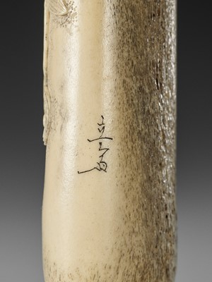 Lot 283 - RYUSAI: A STAG ANTLER KISERUZUTSU WITH BUDDHIST IMAGERY