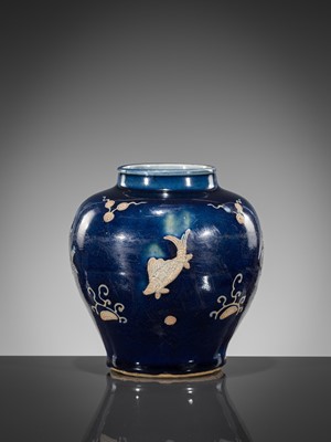 Lot 151 - A BLUE-GLAZED CARVED ‘FISH’ BALUSTER JAR, JIAJING PERIOD, 1521-1567