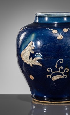 Lot 151 - A BLUE-GLAZED CARVED ‘FISH’ BALUSTER JAR, JIAJING PERIOD, 1521-1567