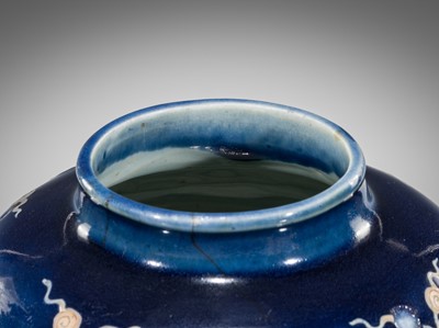 Lot 151 - A BLUE-GLAZED CARVED ‘FISH’ BALUSTER JAR, JIAJING PERIOD, 1521-1567