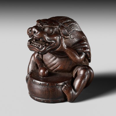 Lot 484 - YASUMASA: A FINE WOOD NETSUKE OF A BOY DRUMMER WITH SHISHIMAI MASK