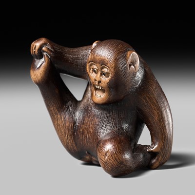 Lot 131 - TOMOKAZU: AN AMUSING WOOD NETSUKE OF AN ACROBATIC MONKEY