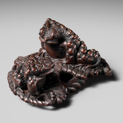 Lot 118 - MASANAO: AN UNUSUAL WOOD NETSUKE OF TOADS ON A WARAJI