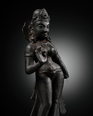 Lot 11 - AN EARLY CAST IRON FIGURE OF TARA, NEPAL, 7TH-8TH CENTURY