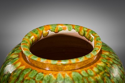 Lot 136 - A SANCAI SPLASHED POTTERY JAR AND COVER, TANG DYNASTY