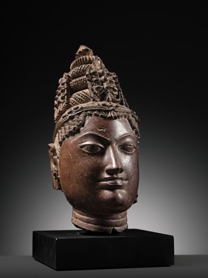 Lot 195 - A RED SANDSTONE HEAD OF VISHNU, WESTERN RAJASTHAN, 12TH-13TH CENTURY