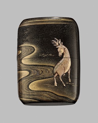 Lot 42 - A FINE BUFFALO HORN-INLAID THREE-CASE INRO OF A DEER AT NIGHT IN KASUGA PARK, NARA