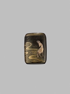 Lot 42 - A FINE BUFFALO HORN-INLAID THREE-CASE INRO OF A DEER AT NIGHT IN KASUGA PARK, NARA