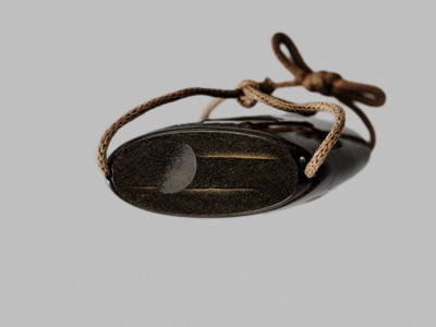 Lot 42 - A FINE BUFFALO HORN-INLAID THREE-CASE INRO OF A DEER AT NIGHT IN KASUGA PARK, NARA