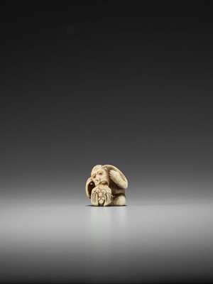 Lot 50 - RANMEI: AN IVORY NETSUKE OF A MONKEY WITH PERSIMMON