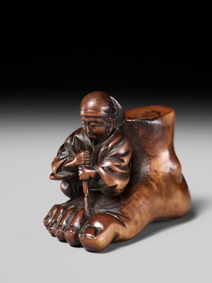 Lot 230 - HOSHUNSAI MASAYUKI: A FINE WOOD NETSUKE OF A CARVER CHISELING A GIANT FOOT