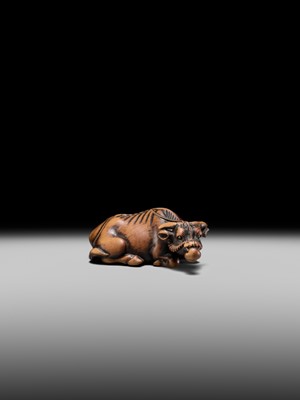 Lot 147 - A SUPERB WOOD NETSUKE OF A RECUMBENT OX, ATTRIBUTED TO OKATOMO