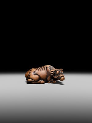 Lot 147 - A SUPERB WOOD NETSUKE OF A RECUMBENT OX, ATTRIBUTED TO OKATOMO