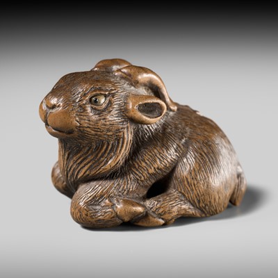 Lot 138 - MINKO: A WOOD NETSUKE OF A RECUMBENT GOAT