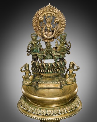 Lot 319 - A LARGE BRASS TEMPLE LAMP DEPICTING SURYA ON HIS CHARIOT, NEPAL, CIRCA 1900