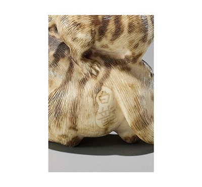 Lot 64 - HAKURYU: AN IVORY NETSUKE OF A TIGER WITH TWO CUBS
