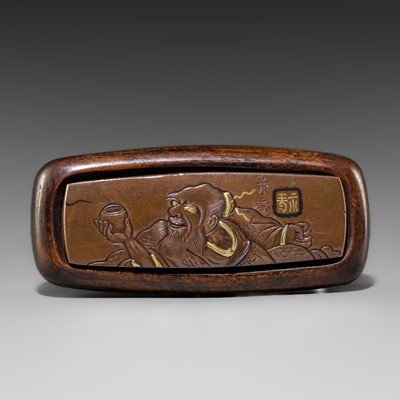 JOI: A WOOD AND SUAKA KAGAMIBUTA NETSUKE OF HANDAKA SONJA