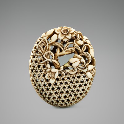 Lot 529 - A FINE WALRUS TUSK RYUSA MANJU NETSUKE WITH CHERRY BLOSSOMS