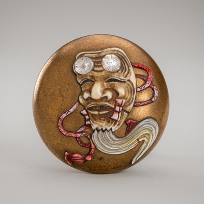 Lot 1372 - SHIBAYAMA: AN INLAID GOLD-LACQUER MANJU NETSUKE DEPICTING AN OKINA MASK