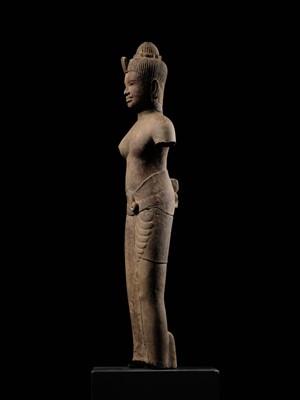 Lot 258 - AN EXCEEDINGLY RARE AND IMPORTANT SANDSTONE FIGURE OF ARDHANARISHVARA, BAPHUON STYLE, ANGKOR PERIOD