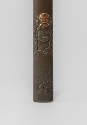 Lot 631 - OKAWA TEIKAN: A SHIBUICHI KOZUKA DEPICTING HOTEI AND KARAKO, AFTER A DESIGN BY HANABUSA ITCHO