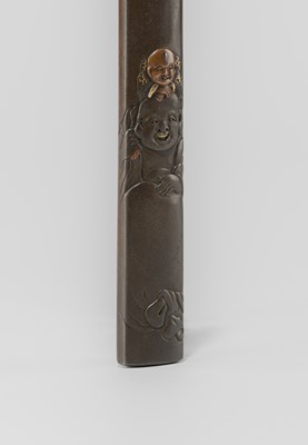 Lot 631 - OKAWA TEIKAN: A SHIBUICHI KOZUKA DEPICTING HOTEI AND KARAKO, AFTER A DESIGN BY HANABUSA ITCHO