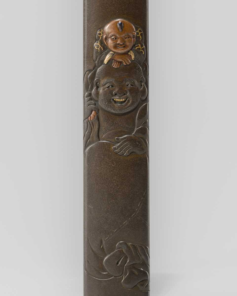 Lot 631 - OKAWA TEIKAN: A SHIBUICHI KOZUKA DEPICTING HOTEI AND KARAKO, AFTER A DESIGN BY HANABUSA ITCHO