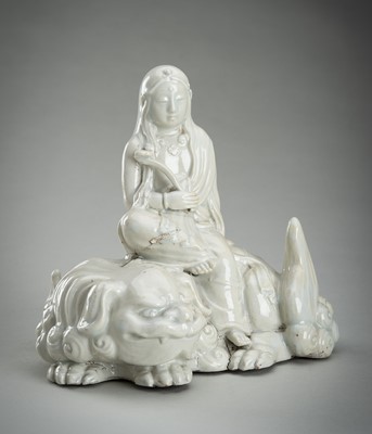 Lot 186 - A HIRADO WHITE-GLAZED PORCELAIN OKIMONO OF KANNON WITH SHISHI