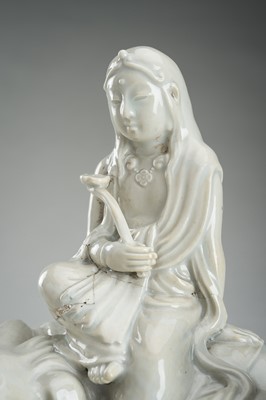 Lot 186 - A HIRADO WHITE-GLAZED PORCELAIN OKIMONO OF KANNON WITH SHISHI