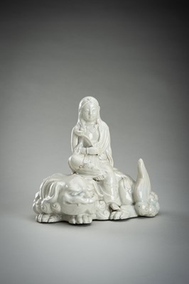 Lot 186 - A HIRADO WHITE-GLAZED PORCELAIN OKIMONO OF KANNON WITH SHISHI