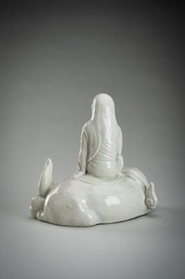 Lot 186 - A HIRADO WHITE-GLAZED PORCELAIN OKIMONO OF KANNON WITH SHISHI