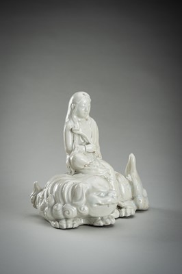 Lot 186 - A HIRADO WHITE-GLAZED PORCELAIN OKIMONO OF KANNON WITH SHISHI