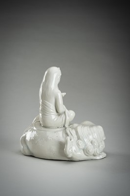 Lot 186 - A HIRADO WHITE-GLAZED PORCELAIN OKIMONO OF KANNON WITH SHISHI