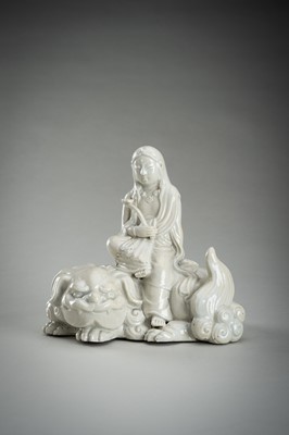 Lot 186 - A HIRADO WHITE-GLAZED PORCELAIN OKIMONO OF KANNON WITH SHISHI