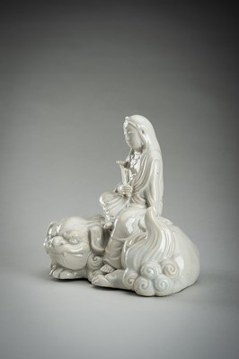 Lot 186 - A HIRADO WHITE-GLAZED PORCELAIN OKIMONO OF KANNON WITH SHISHI