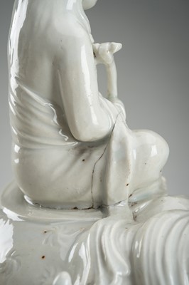 Lot 186 - A HIRADO WHITE-GLAZED PORCELAIN OKIMONO OF KANNON WITH SHISHI
