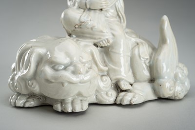 Lot 186 - A HIRADO WHITE-GLAZED PORCELAIN OKIMONO OF KANNON WITH SHISHI