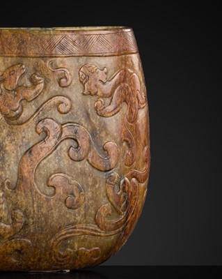 Lot 447 - A RUSSET AND BROWN JADE ‘CHILONG’ LIBATION CUP, MING DYNASTY