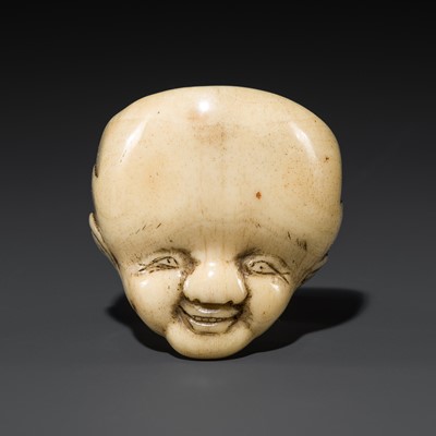 Lot 513 - AN UNUSUAL ANTLER MASK NETSUKE OF FUKUSUKE