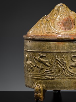 A GREEN-GLAZED POTTERY ‘HILL’ TRIPOD JAR AND COVER, LIAN, HAN DYNASTY