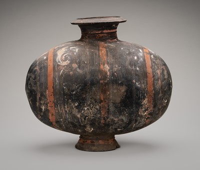 Lot 865 - AN ABSTRACTLY PAINTED POTTERY COCOON JAR, HAN DYNASTY