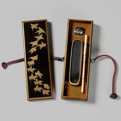 Lot 300 - A RARE BLACK AND GOLD LACQUER SLENDER SUZURIBAKO WITH PLOVERS IN FLIGHT