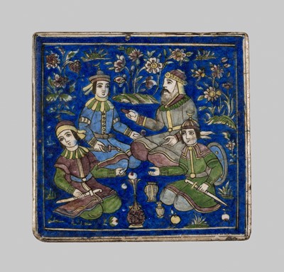 Lot 365 - A MOLDED QAJAR ‘COURTIERS AT A PICNIC’ TILE